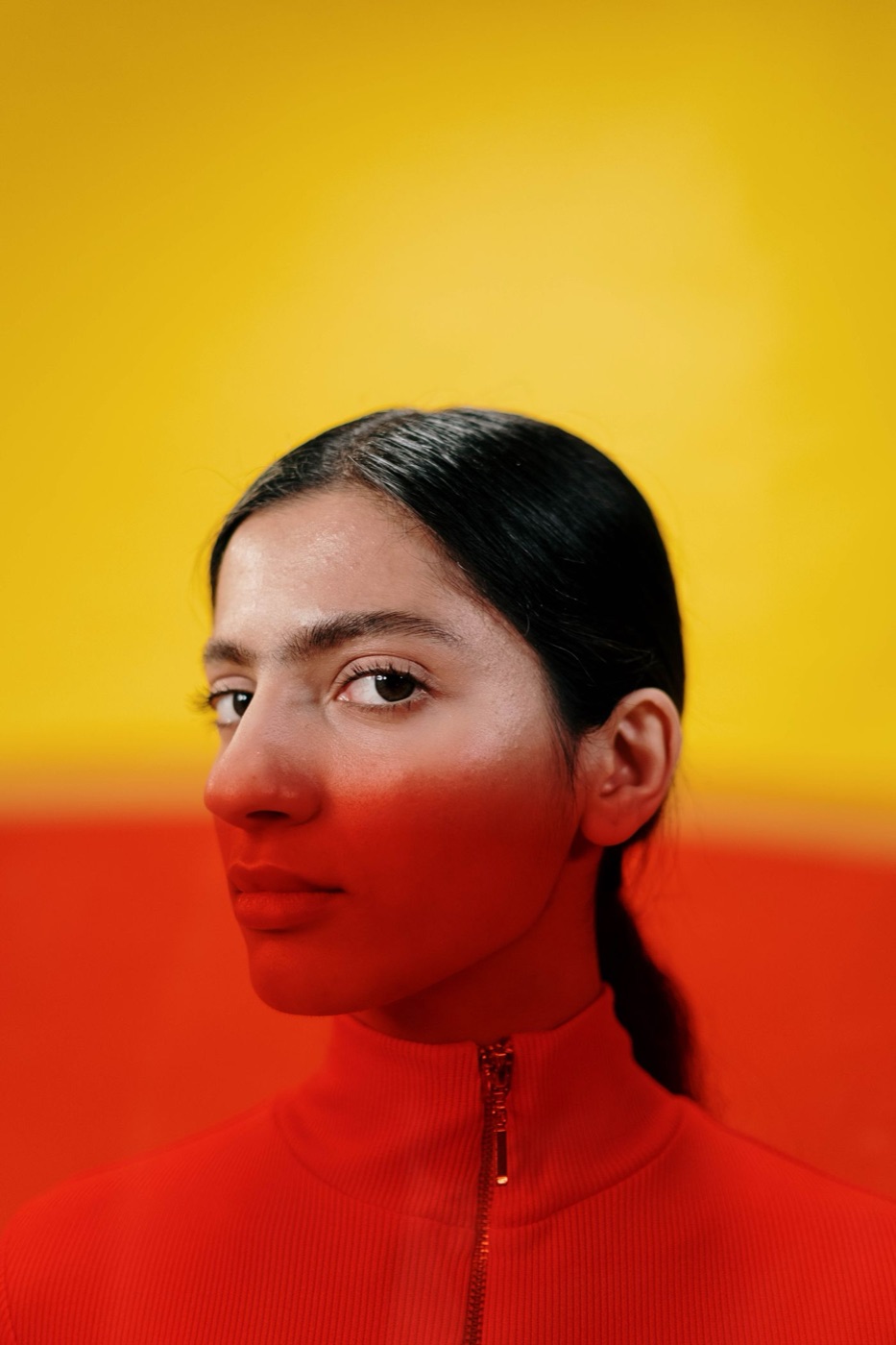 Young woman in red against a yellow background