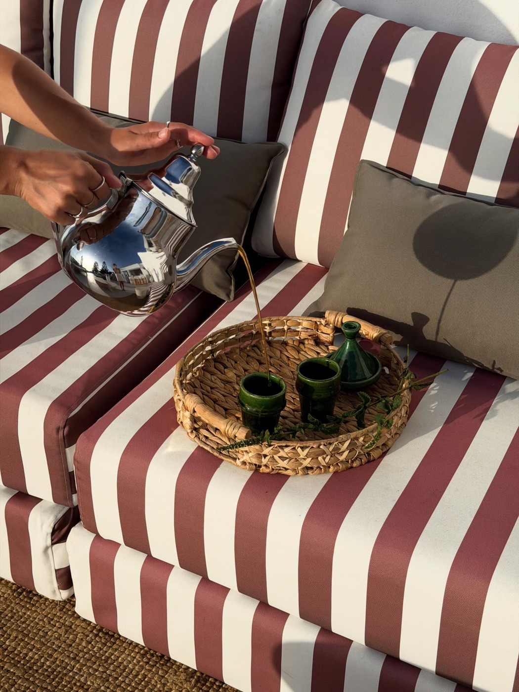 Mint tea being poured on a striped terrace at Maison Simonetta