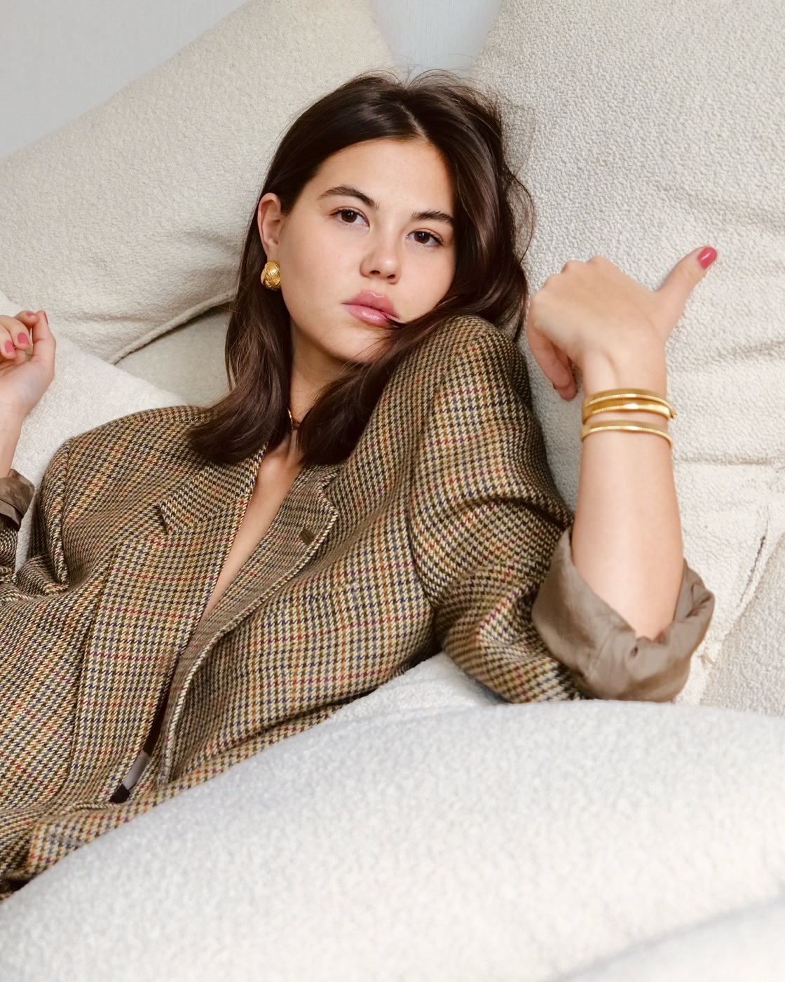 Leyl Jewels muse in a tweed blazer wearing gold bangles